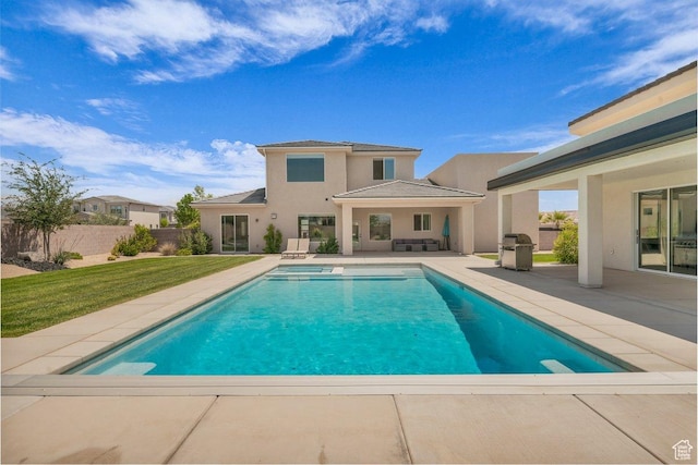 2938 S Poplar Ln, St George, UT 84790 - view of swimming pool featuring a patio area, a pool with connected hot tub, and an outdoor living space