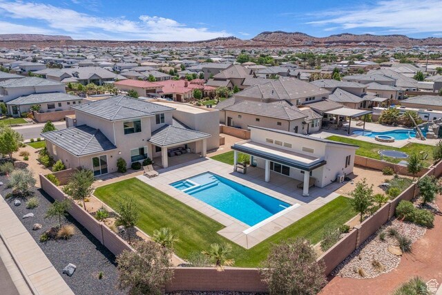 2938 S Poplar Ln, St George, UT 84790 - view of swimming pool with a pool with connected hot tub, a residential view, a patio area, and a mountain view