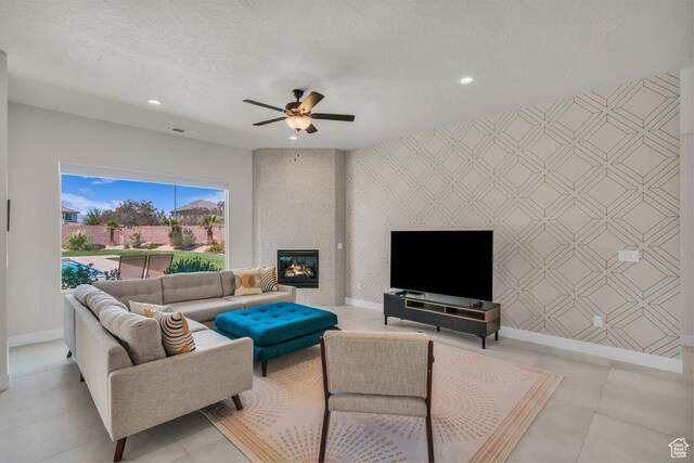 2938 S Poplar Ln, St George, UT 84790 - living room featuring wallpapered walls, baseboards, recessed lighting, ceiling fan, and a large fireplace