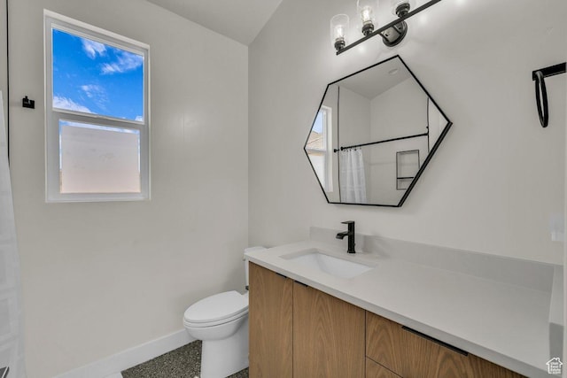 2938 S Poplar Ln, St George, UT 84790 - bathroom with baseboards, toilet, vanity, and healthy amount of natural light