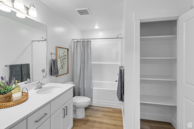247 W 925 N Unit I49, Brigham City, UT 84302 - bathroom featuring wood finished floors, vanity, toilet, shower / bathtub combination with curtain, and recessed lighting