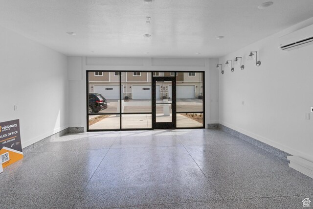 247 W 925 N Unit I49, Brigham City, UT 84302 - unfurnished room with speckle patterned floor, an AC wall unit, and baseboards