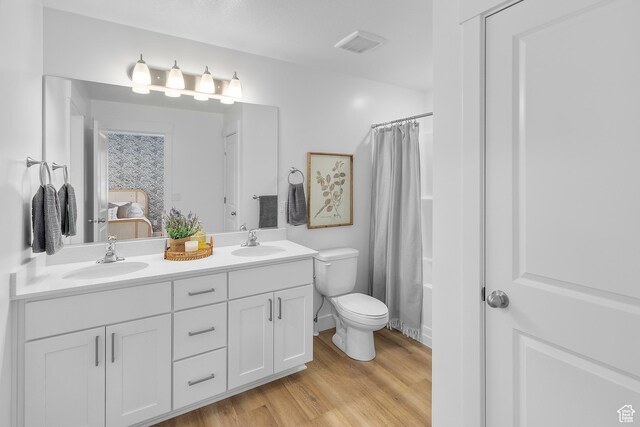 247 W 925 N Unit I49, Brigham City, UT 84302 - full bathroom featuring toilet, wood finished floors, double vanity, ensuite bath, and a shower with shower curtain