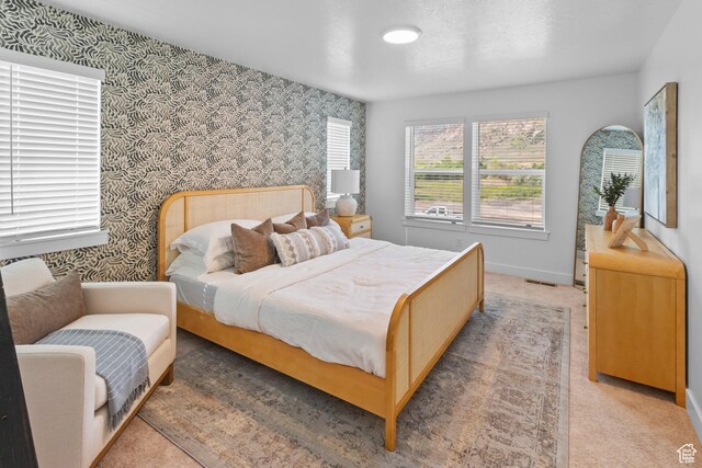 247 W 925 N Unit I49, Brigham City, UT 84302 - bedroom featuring wallpapered walls, baseboards, and light colored carpet