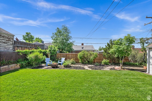 view of yard with a fire pit