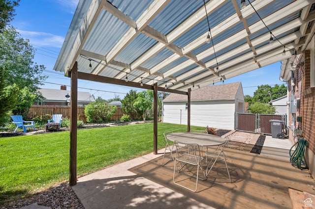 view of patio / terrace with cooling unit, a fire pit, an outbuilding, and outdoor dining space