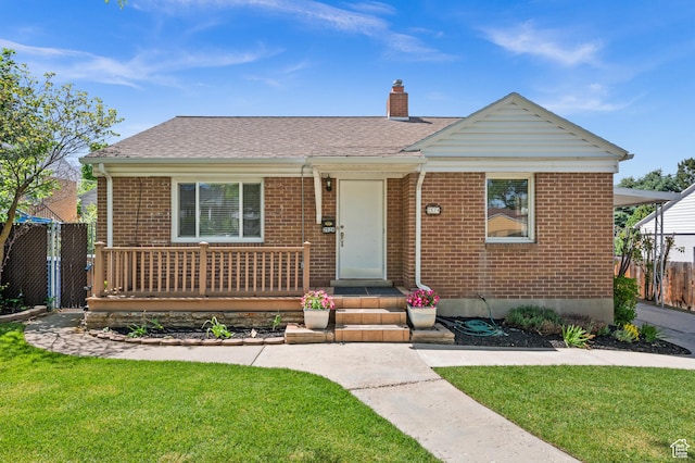 view of front of home with brick siding, a chimney, and a shingled roof