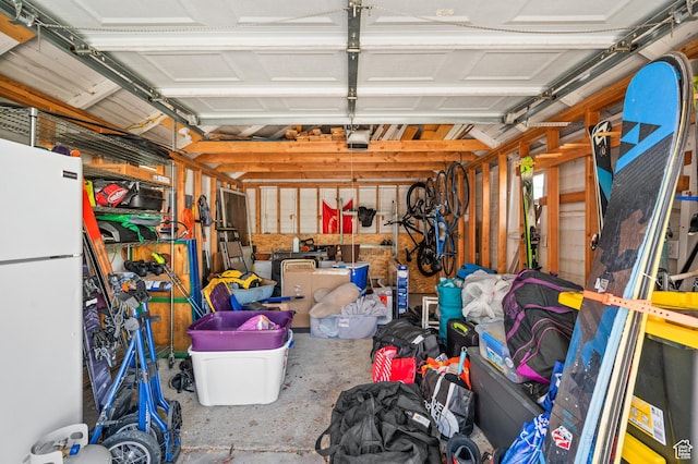 garage with freestanding refrigerator and a garage door opener