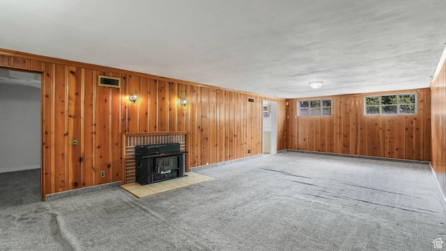 255 N A St E, Salt Lake City, UT 84103 - unfurnished living room with carpet floors, wooden walls, and a wood stove
