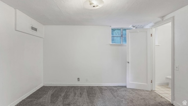 255 N A St E, Salt Lake City, UT 84103 - below grade area with baseboards, carpet floors, and a textured ceiling
