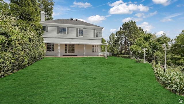 255 N A St E, Salt Lake City, UT 84103 - back of property with a chimney, a yard, and a patio area