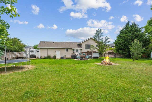 1447 E 230 S, Spanish Fork, UT 84660 - back of house with a trampoline and an outdoor fire pit
