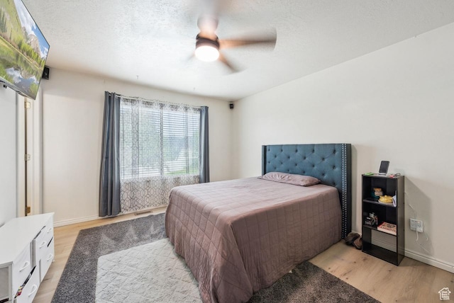 1447 E 230 S, Spanish Fork, UT 84660 - bedroom with light wood-style flooring, baseboards, ceiling fan, and a textured ceiling