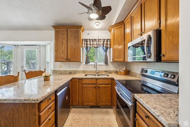 1447 E 230 S, Spanish Fork, UT 84660 - kitchen with stainless steel appliances, a sink, a peninsula, and brown cabinetry