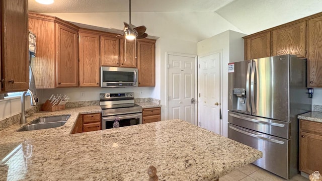 1447 E 230 S, Spanish Fork, UT 84660 - kitchen with appliances with stainless steel finishes, a sink, light stone counters, brown cabinets, and lofted ceiling