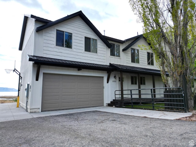 2500 N Bear Lake Blvd, Garden City, UT 84028 - view of front of house with a porch, a standing seam roof, metal roof, and an attached garage