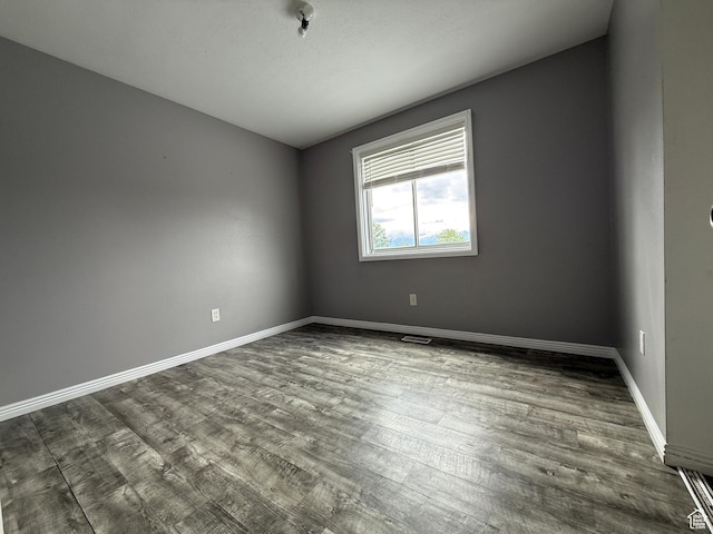 6351 S Moki Cir W, West Jordan, UT 84081 - spare room featuring dark wood-style floors and baseboards
