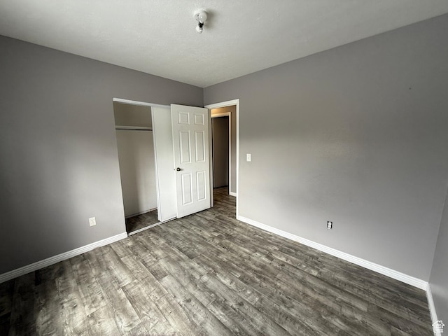 6351 S Moki Cir W, West Jordan, UT 84081 - unfurnished bedroom with dark wood finished floors, baseboards, and a closet