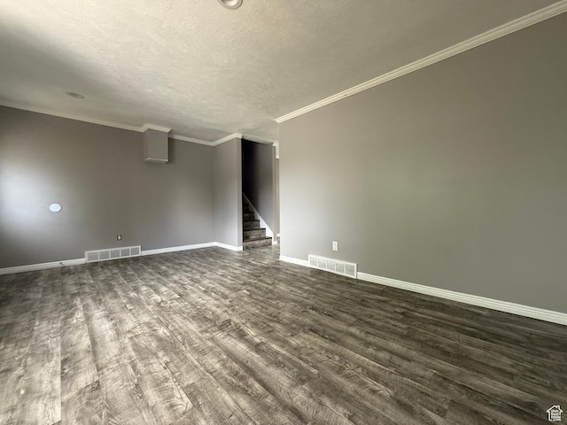 6351 S Moki Cir W, West Jordan, UT 84081 - spare room with dark wood finished floors, baseboards, stairway, a textured ceiling, and ornamental molding