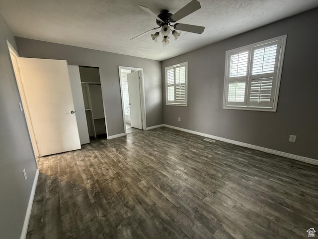 6351 S Moki Cir W, West Jordan, UT 84081 - unfurnished bedroom with dark wood-style flooring, a textured ceiling, and baseboards