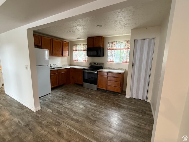 6351 S Moki Cir W, West Jordan, UT 84081 - kitchen featuring stainless steel electric range oven, freestanding refrigerator, black microwave, a sink, and dark wood-style floors