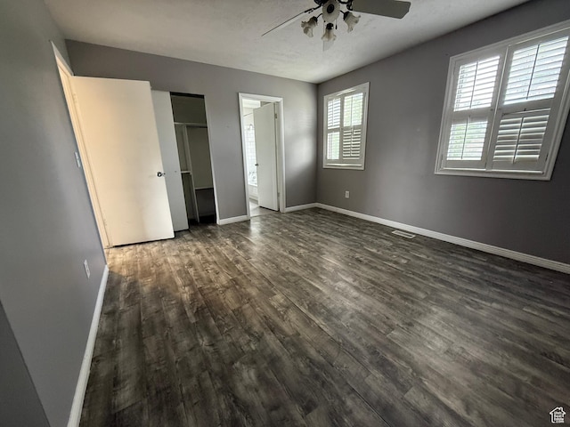 6351 S Moki Cir W, West Jordan, UT 84081 - unfurnished bedroom with dark wood-style flooring, baseboards, and ceiling fan