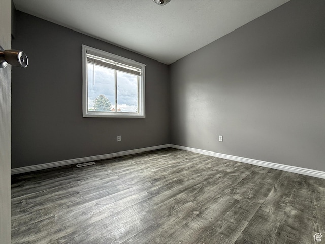 6351 S Moki Cir W, West Jordan, UT 84081 - spare room featuring dark wood finished floors and baseboards
