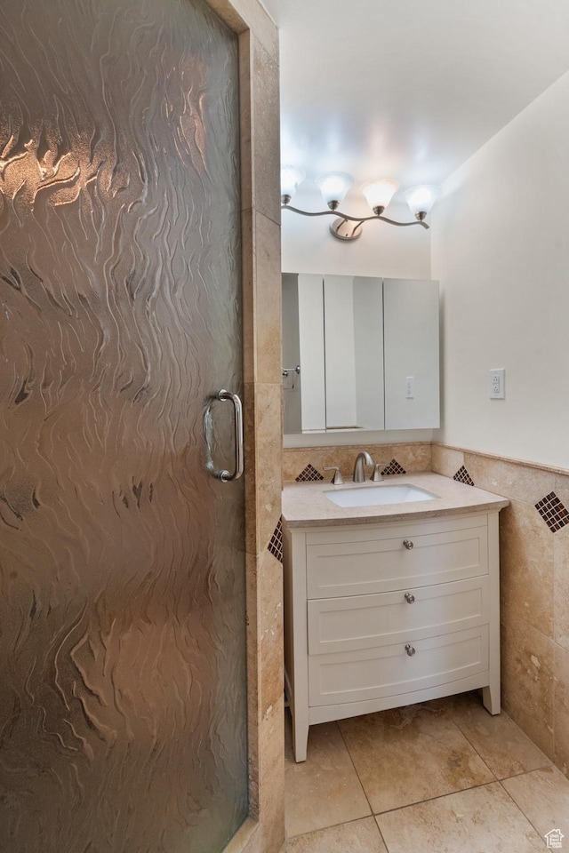 bathroom featuring tile walls, vanity, and a shower stall