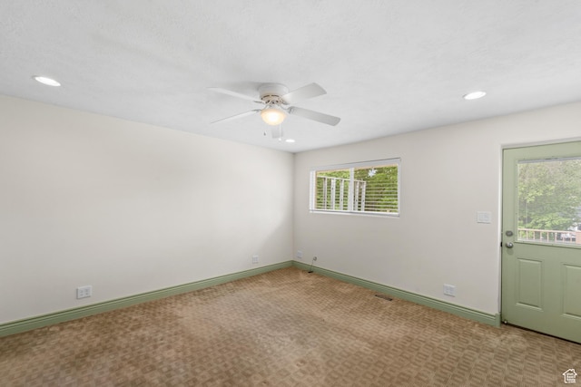 unfurnished room with plenty of natural light, ceiling fan, recessed lighting, carpet flooring, and baseboards