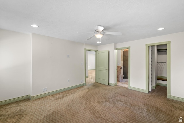 unfurnished bedroom with carpet floors, recessed lighting, baseboards, connected bathroom, and ceiling fan
