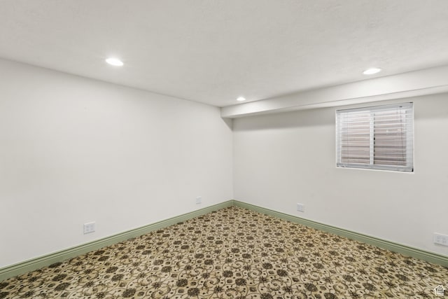basement featuring recessed lighting, baseboards, and tile patterned floors