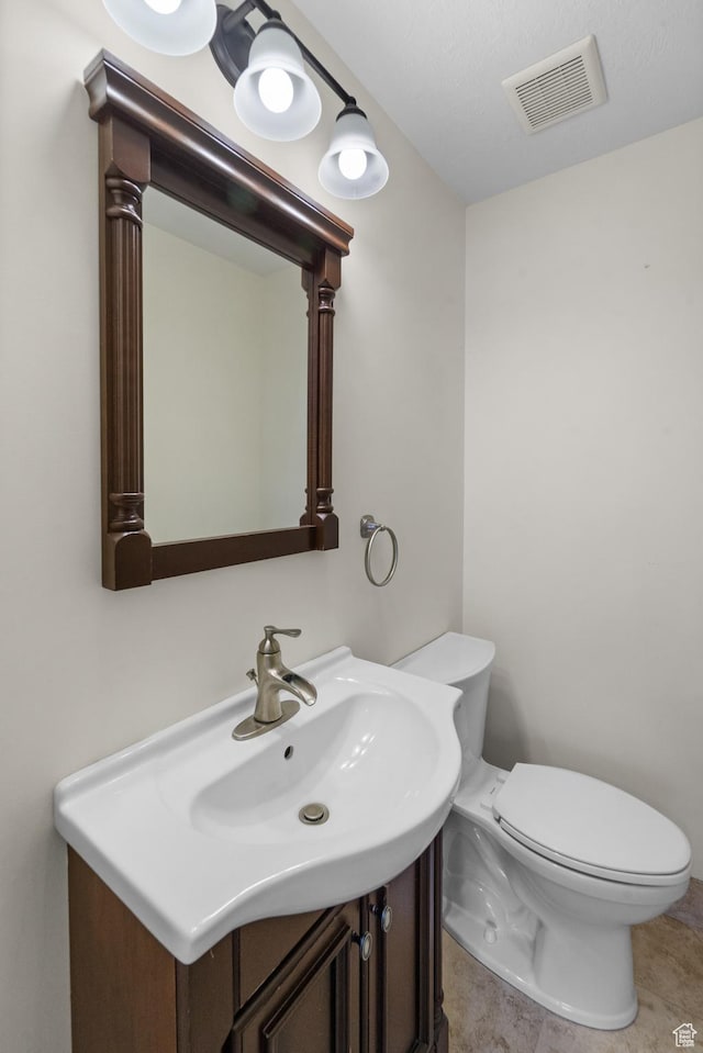 half bathroom featuring toilet and vanity