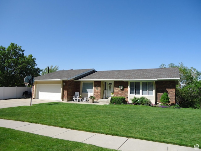 ranch-style house featuring brick siding, driveway, and a garage