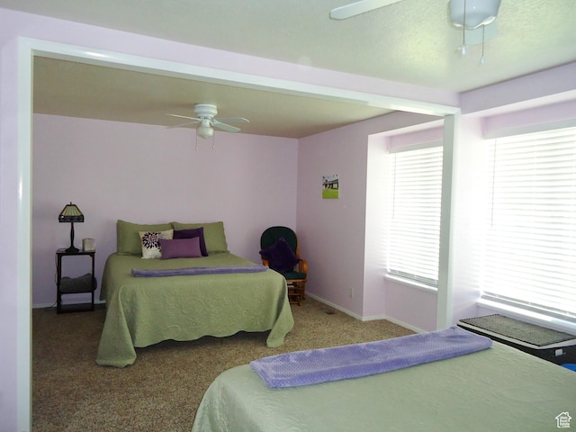 bedroom with carpet, ceiling fan, and baseboards