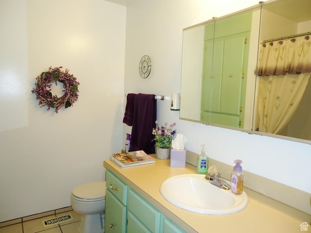 full bath featuring vanity, tile patterned floors, and toilet