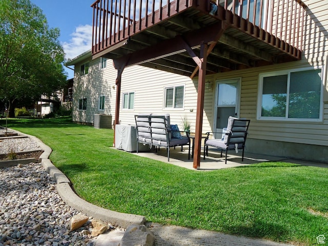 rear view of property with a patio area, a lawn, and central AC unit