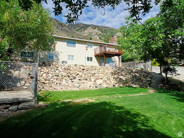 view of yard with a deck with mountain view