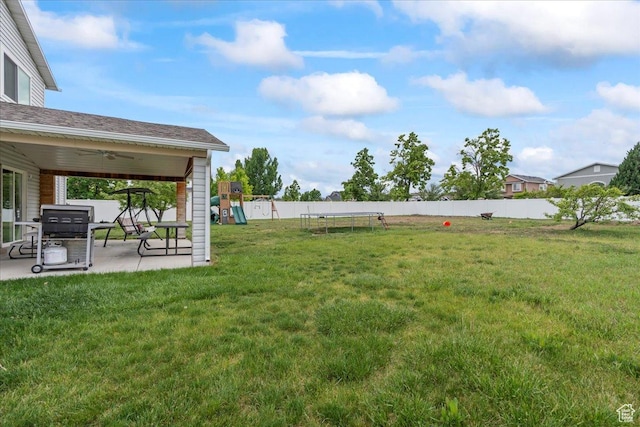 view of yard with a playground, a patio, and a ceiling fan