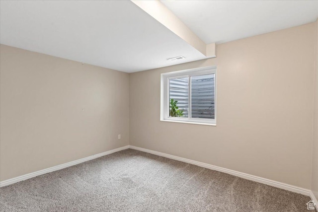 empty room featuring carpet flooring and baseboards