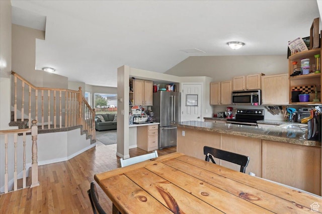 kitchen featuring appliances with stainless steel finishes, open shelves, light brown cabinetry, light wood-type flooring, and lofted ceiling