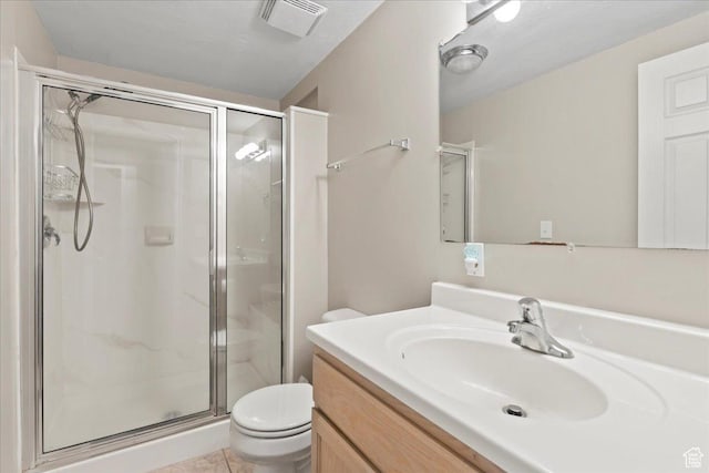 bathroom with toilet, a stall shower, vanity, and tile patterned floors