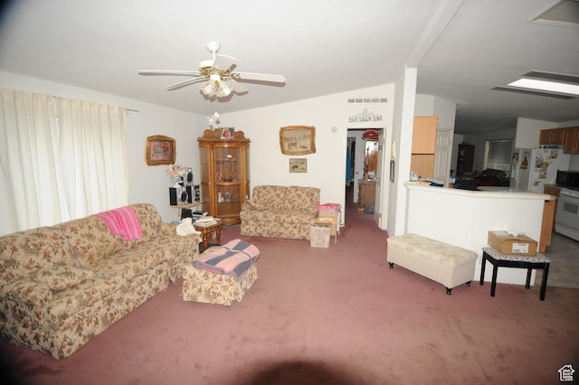 living room featuring carpet flooring, a ceiling fan, and lofted ceiling