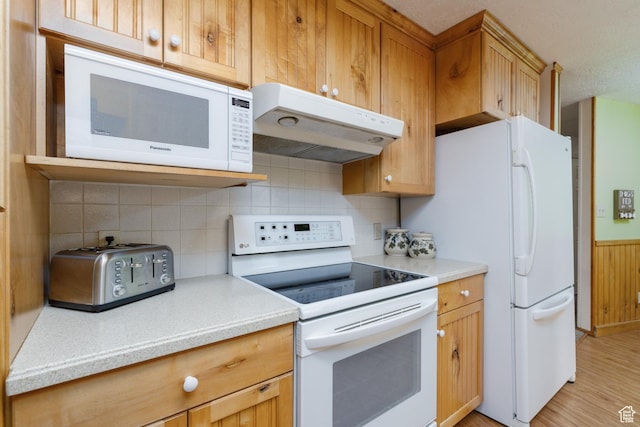 2147 N 3850 E, Eden, UT 84310 - kitchen featuring white appliances, under cabinet range hood, light countertops, decorative backsplash, and light wood-style flooring