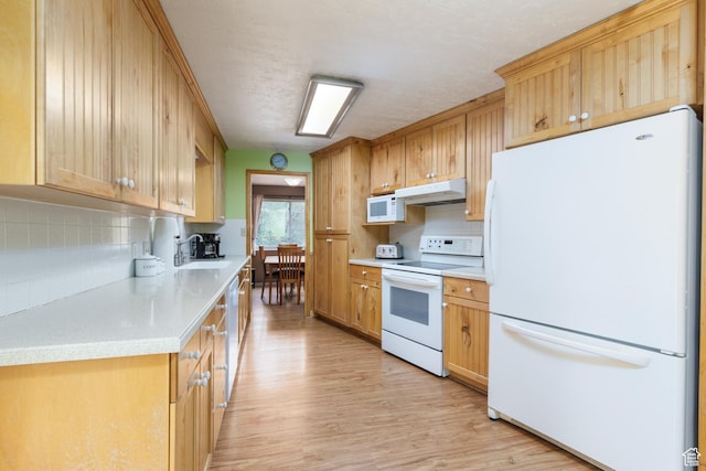2147 N 3850 E, Eden, UT 84310 - kitchen featuring white appliances, under cabinet range hood, light wood-style flooring, and backsplash