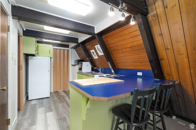 2147 N 3850 E, Eden, UT 84310 - kitchen featuring freestanding refrigerator, green cabinets, a sink, light wood-style floors, and a peninsula