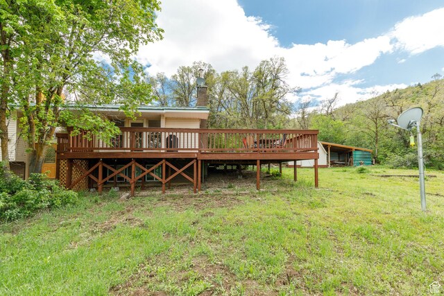 2147 N 3850 E, Eden, UT 84310 - back of house with a wooden deck, a lawn, and a chimney