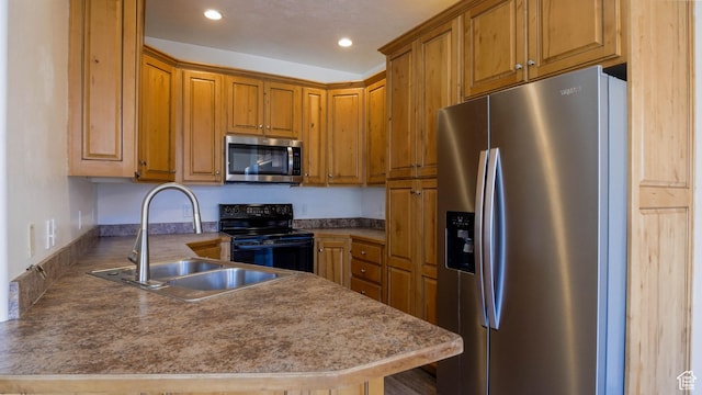 635 E 60 S Unit A-3, American Fork, UT 84003 - kitchen featuring appliances with stainless steel finishes, a sink, brown cabinets, a peninsula, and recessed lighting