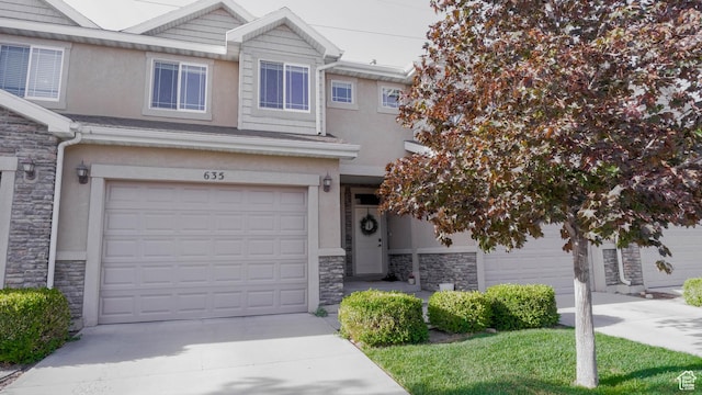 635 E 60 S Unit A-3, American Fork, UT 84003 - view of property featuring stone siding, stucco siding, an attached garage, and concrete driveway