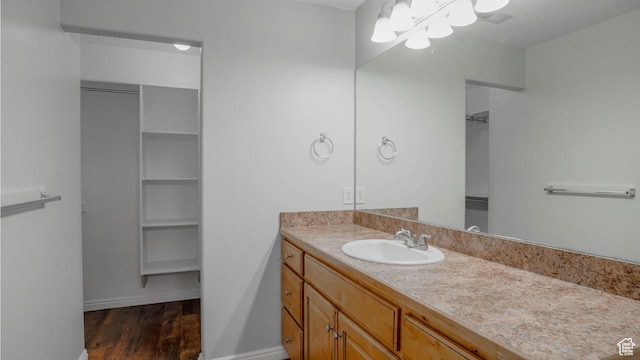 635 E 60 S Unit A-3, American Fork, UT 84003 - bathroom with wood finished floors, a chandelier, vanity, baseboards, and a walk in closet