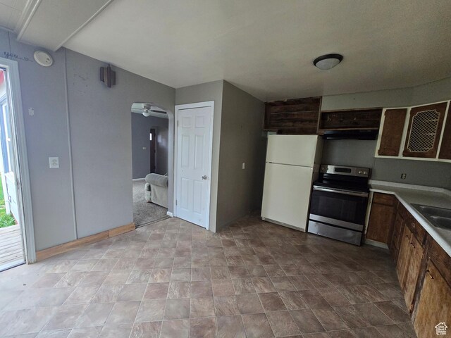 616 Jefferson St, Montpelier, ID 83254 - kitchen with stainless steel electric range, freestanding refrigerator, ceiling fan, light countertops, and under cabinet range hood